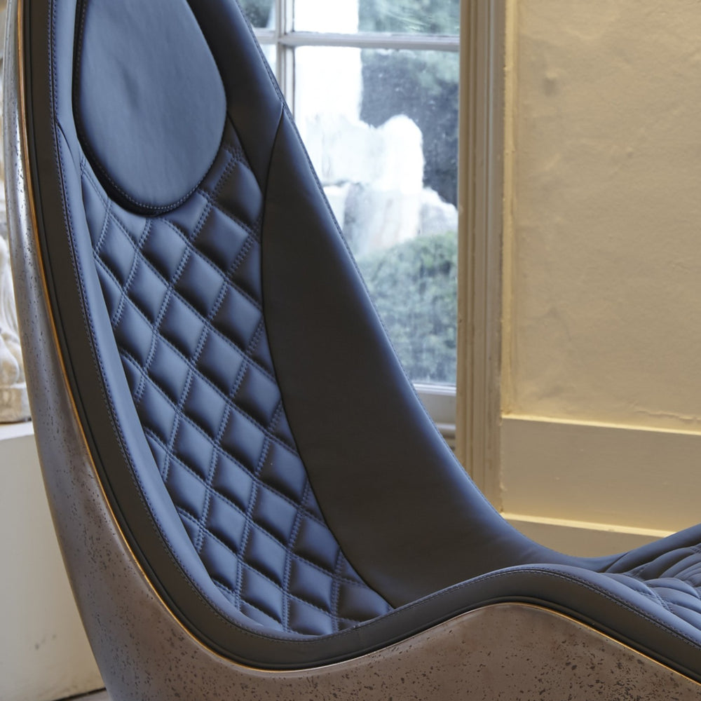 “Caillou Chaise – Leather & Bronze” by Ben Rousseau – a sculptural chaise combining deep navy quilted leather with a liquid bronze base. A handcrafted fusion of strength and sophistication, redefining modern luxury furniture.