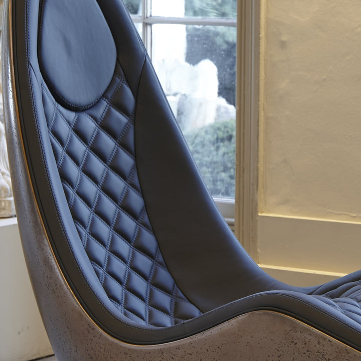 “Caillou Chaise – Leather & Bronze” by Ben Rousseau – a sculptural chaise combining deep navy quilted leather with a liquid bronze base. A handcrafted fusion of strength and sophistication, redefining modern luxury furniture.