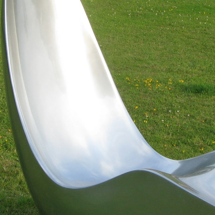 “Caillou Chaise – Metallic Wet Spray” by Ben Rousseau – a sculptural chaise inspired by 1960s grand tourers, hand-shaped in composite with a high-gloss metallic lacquered finish in white, lime, gold, or silver. A fusion of luxury design and form.