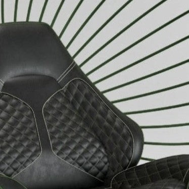 “California Chair – Standing Car Trim” by Ben Rousseau – a sculptural chair with a green powder-coated steel frame and quilted black leather upholstery inspired by 1980s sports car interiors. A bold fusion of craftsmanship, design, and automotive luxury.
