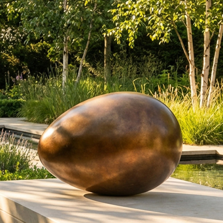 Patinated bronze Creation egg sculpture by James Parker, with a smooth rounded form symbolising fragility, containment, potential and birth.