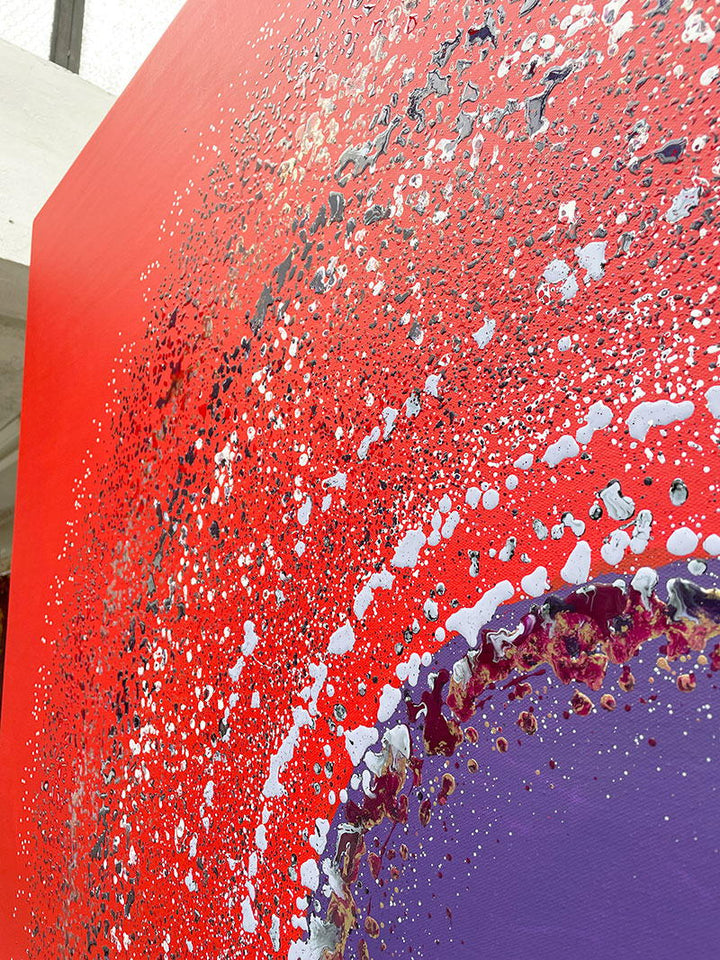 Large abstract painting “Ellipsis” by Swarez — bold square composition with a deep violet central circle surrounded by concentric rings of paint droplets and splashes on a vivid matte red background. Energetic, dynamic halo effect created by spin technique.