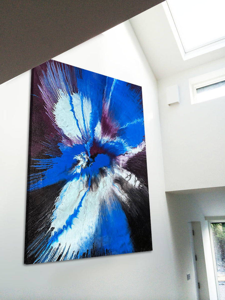 Large abstract painting “Atomic Butterfly” by Swarez — dramatic centrifugal spin art with explosive bursts of cobalt blue, electric turquoise, deep violet purple, crisp white, and black radiating from the centre across a heavily textured enamel surface.