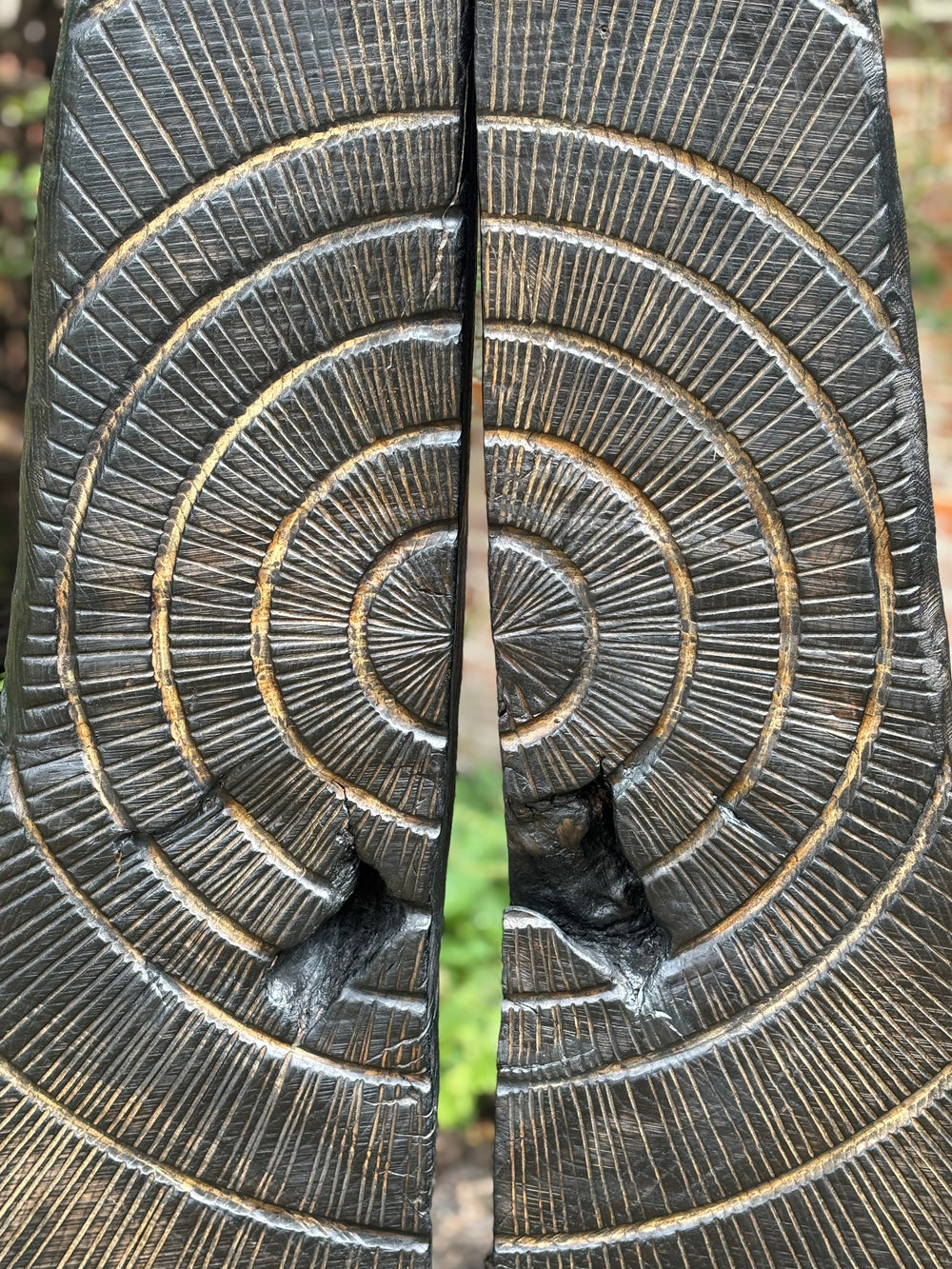 Glen Farrelly sculpture First Breath Again, a 125cm tall one-off carved from reclaimed unwanted oak. The form features two upright sections with a central split, radiating circular carvings echoing tree rings and energy pulses. Charred blackened oak reveals warm golden-brown undertones, symbolising renewal, sustainability, and the power of nature reclaimed. A striking contemporary work for both gardens and interior display, balancing raw presence with contemplative form.