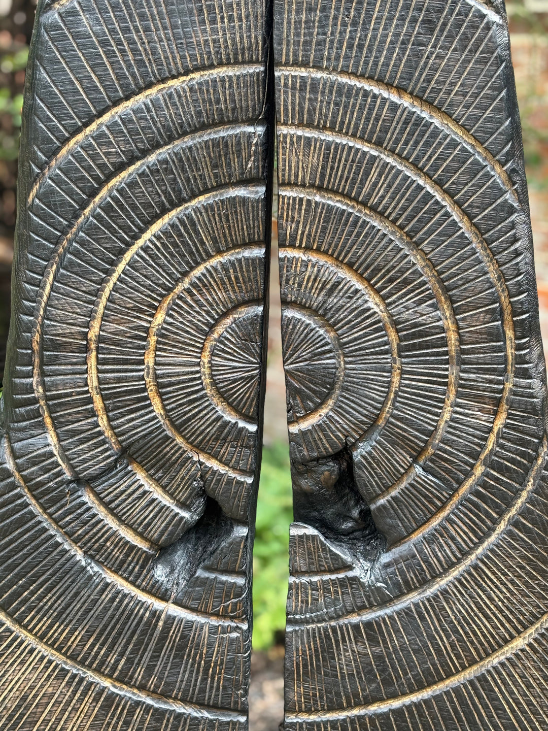 Glen Farrelly sculpture First Breath Again, a 125cm tall one-off carved from reclaimed unwanted oak. The form features two upright sections with a central split, radiating circular carvings echoing tree rings and energy pulses. Charred blackened oak reveals warm golden-brown undertones, symbolising renewal, sustainability, and the power of nature reclaimed. A striking contemporary work for both gardens and interior display, balancing raw presence with contemplative form.