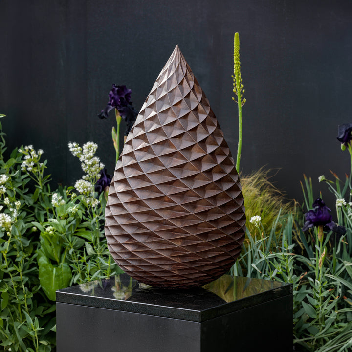 Patinated bronze Pine Cone sculpture by James Parker, with an interlocking spiral surface, geometric scale pattern and tapered organic form inspired by nature and Fibonacci structure.