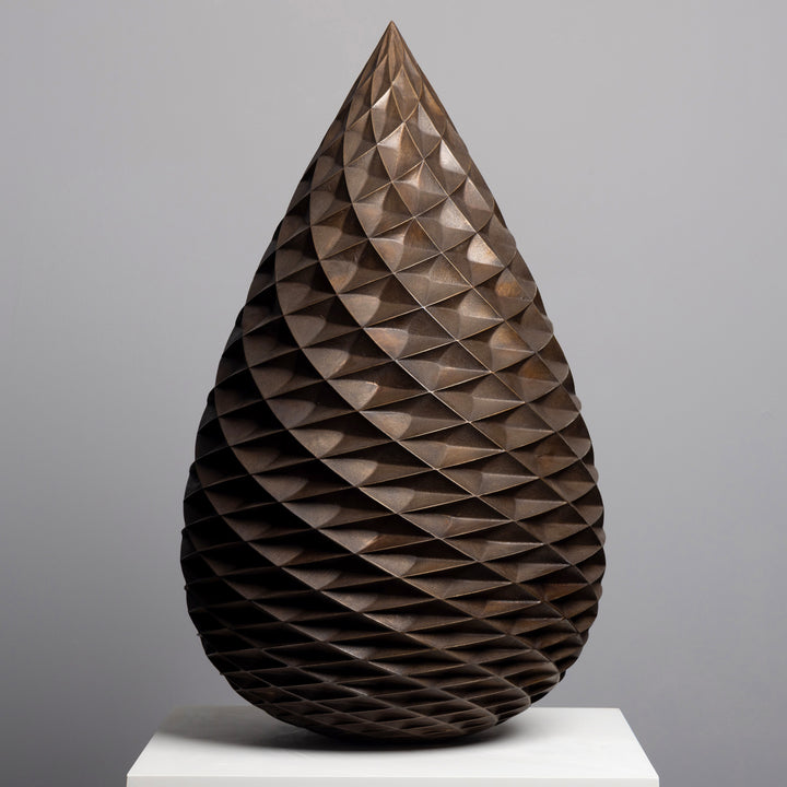 Patinated bronze Pine Cone sculpture by James Parker, with an interlocking spiral surface, geometric scale pattern and tapered organic form inspired by nature and Fibonacci structure.