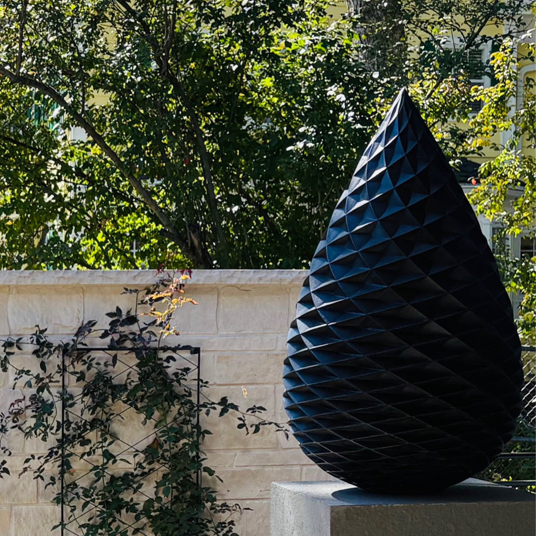 Patinated bronze Pine Cone sculpture by James Parker, with an interlocking spiral surface, geometric scale pattern and tapered organic form inspired by nature and Fibonacci structure.
