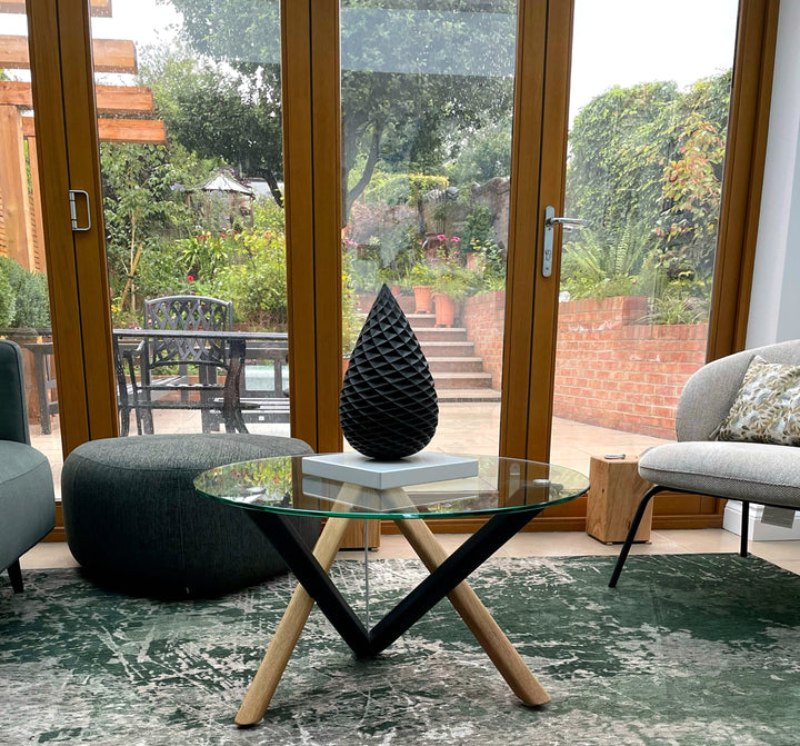 Patinated bronze Pine Cone sculpture by James Parker, with an interlocking spiral surface, geometric scale pattern and tapered organic form inspired by nature and Fibonacci structure.