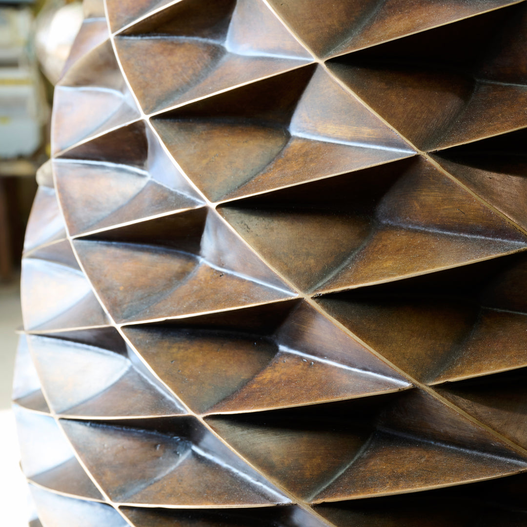 Patinated bronze Pine Cone sculpture by James Parker, with an interlocking spiral surface, geometric scale pattern and tapered organic form inspired by nature and Fibonacci structure.