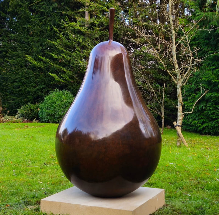 Patinated bronze Pear sculpture by James Parker, with a smooth refined surface, natural stem and generous organic form symbolising abundance, balance and longevity.