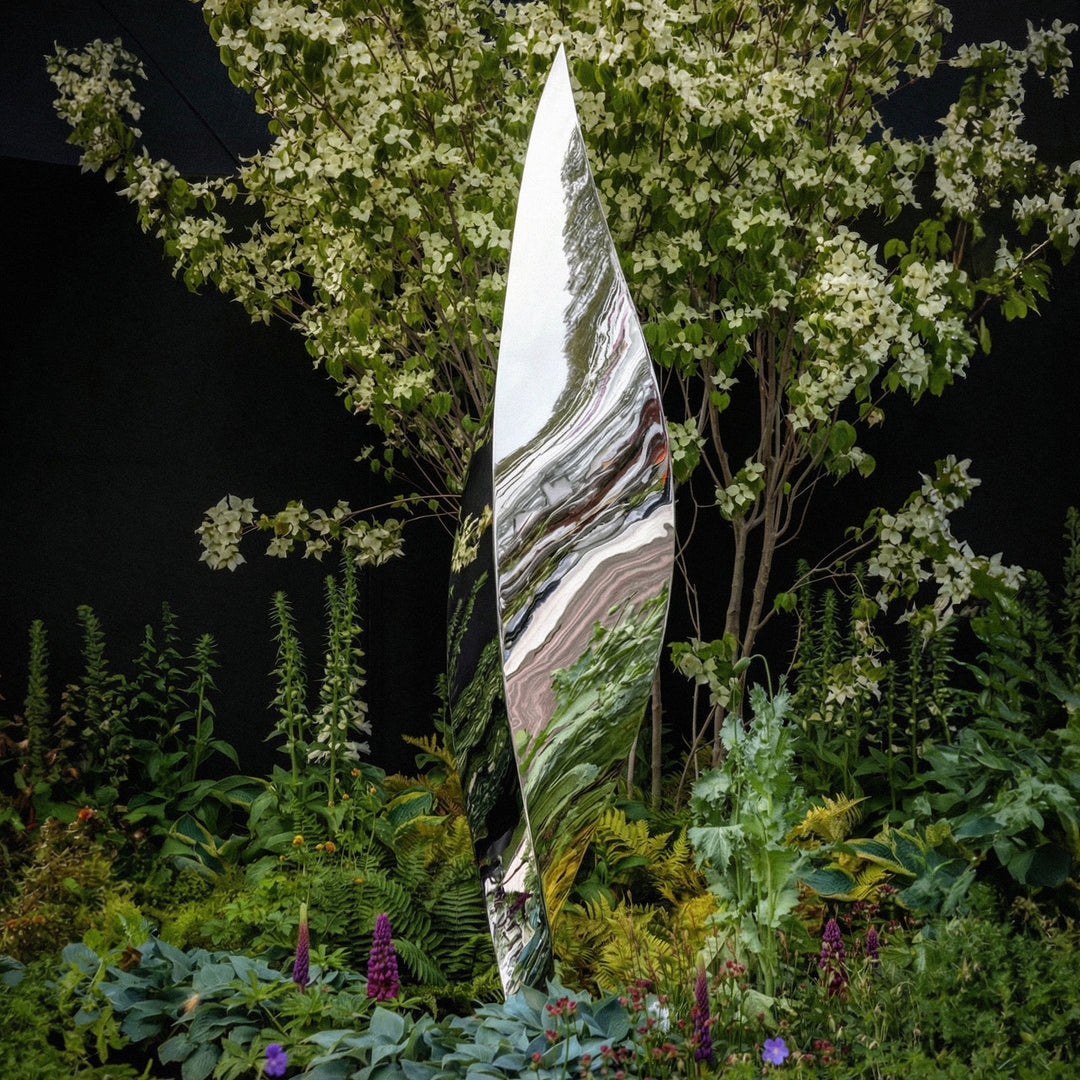 Mirror-polished stainless steel Leaf sculpture by James Parker, with a tall twisting three-sided form inspired by balance, movement and natural renewal.