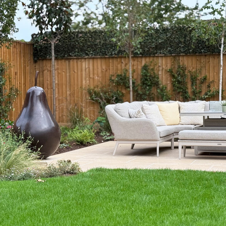 Patinated bronze Pear sculpture by James Parker, with a smooth refined surface, natural stem and generous organic form symbolising abundance, balance and longevity.