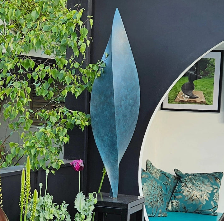 Patinated bronze Leaf sculpture by James Parker, with a gently twisting three-sided form inspired by balance, movement and natural renewal.