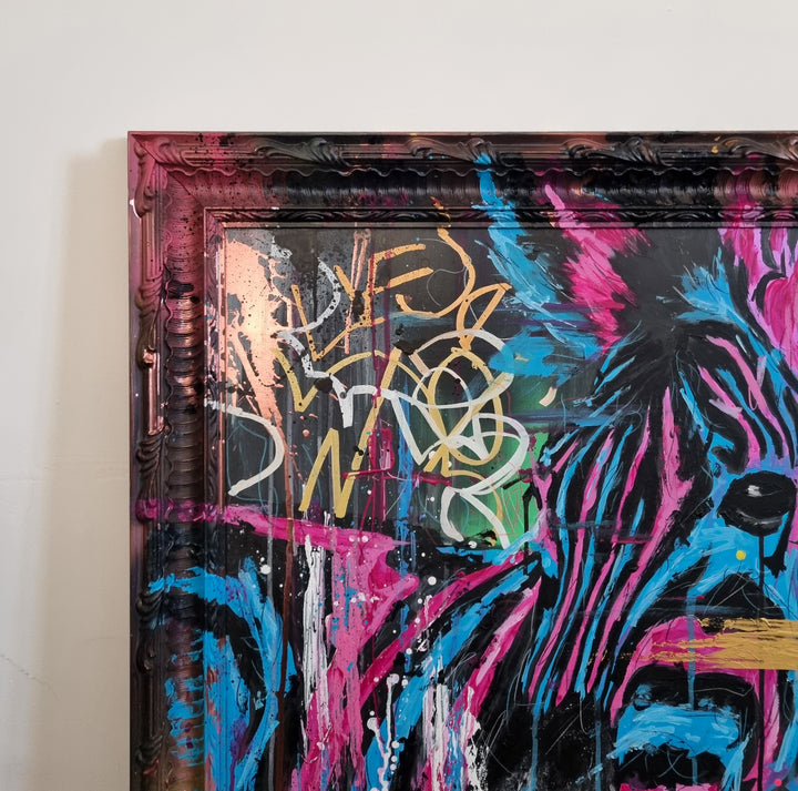 Bold graffiti-style painting of a vibrant zebra titled Equiferus, featuring intense pink, electric blue, black and neon yellow tones, with expressive acrylic and spray paint strokes extending onto a custom-painted ornate frame.