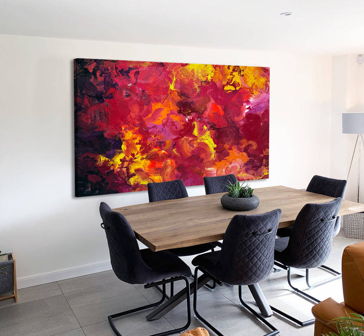 Large abstract painting “Crocosmia” by Swarez — vibrant swirling composition of fiery reds, deep crimson, burnt orange, radiant yellow, and accents of magenta, pink, purple, black, and white. Expressive layered enamel paint with fluid circular motions and botanical-inspired energy.