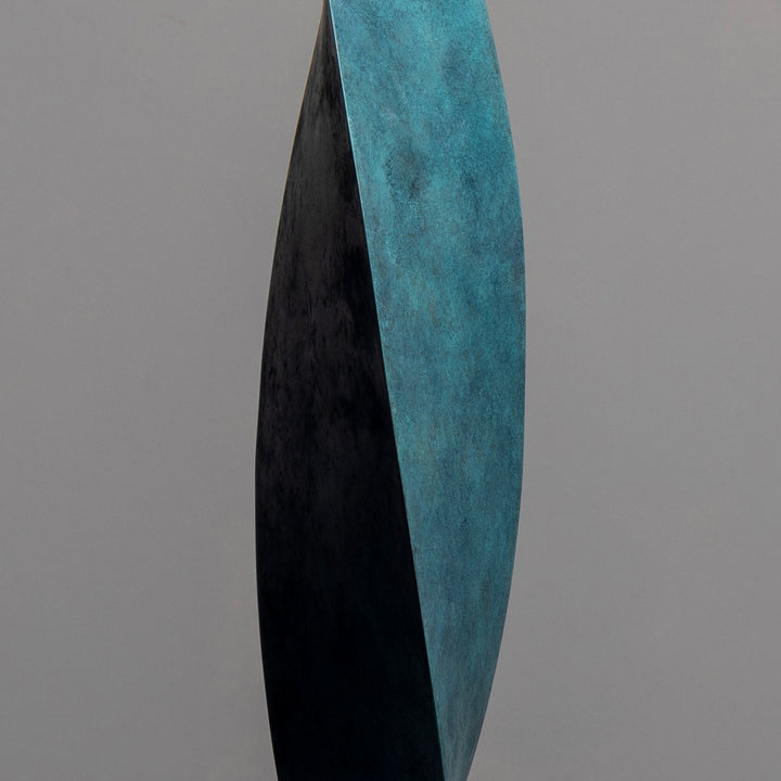 Patinated bronze Leaf sculpture by James Parker, with a gently twisting three-sided form inspired by balance, movement and natural renewal.