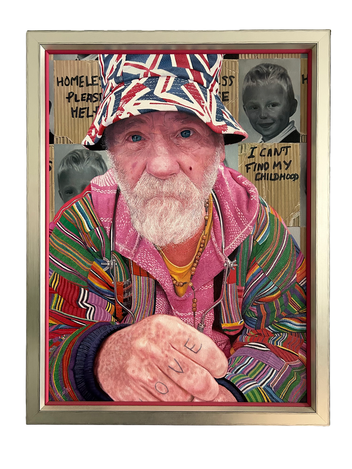 Mick by James Earley — a hyperrealist oil painting of an elderly homeless man in a colourful patchwork jacket and Union Jack bucket hat, staring directly at the viewer with blue eyes full of depth and resilience, his knuckles spelling “LOVE.” Behind him, cardboard signs and childhood photos evoke themes of loss, survival, and invisible trauma.