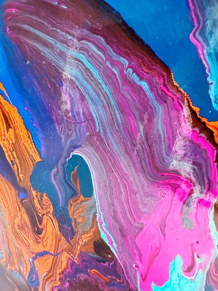 Large abstract painting “Into the Blue” by Swarez — deep ocean-inspired composition with layered shades of cobalt, ultramarine, turquoise, and teal blue. Vivid bursts of fiery orange, vibrant fuchsia, aqua, and rich purple emerge in the centre, with swirling, glossy enamel textures creating movement and depth.