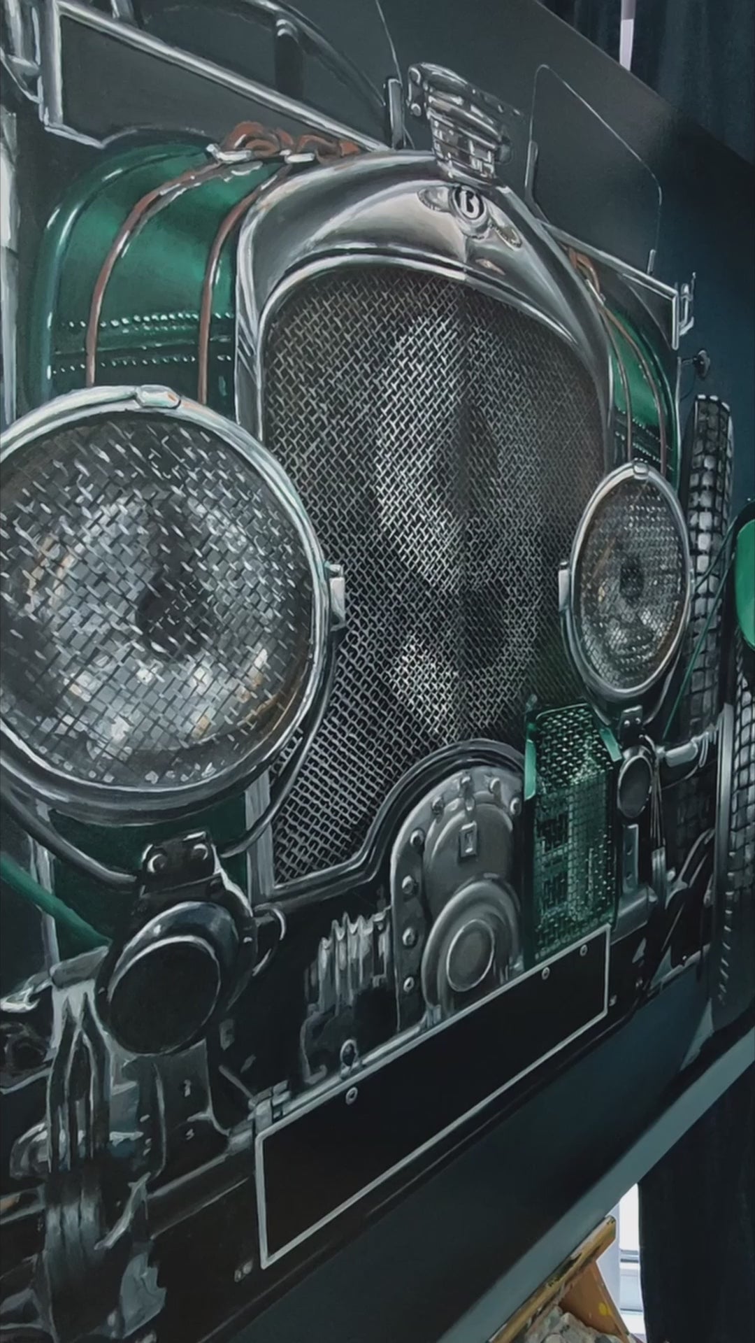 Video of Hyperrealistic frontal portrait of a 1929 Bentley Blower racing car painted with striking precision. The deep British racing green body, polished chrome grille, and massive headlights dominate the dark backdrop, creating a monumental, almost living presence. Rich mechanical textures and metallic reflections celebrate engineering heritage and pre-war endurance racing glory.