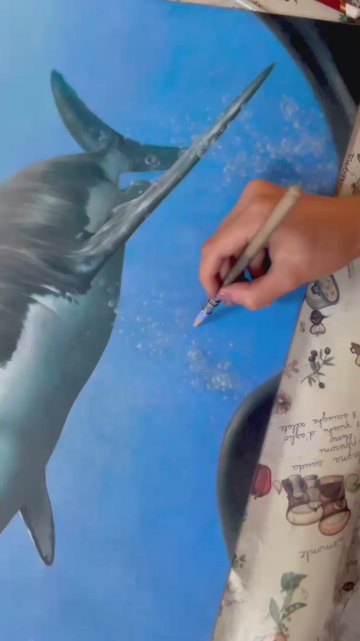 Great White, an original coloured pencil artwork on dark grey Pastelmat board, depicting a hyperrealistic great white shark seen through the curved lens of a diver’s mask, with vivid blue ocean depth, light reflections, and lifelike detailing.