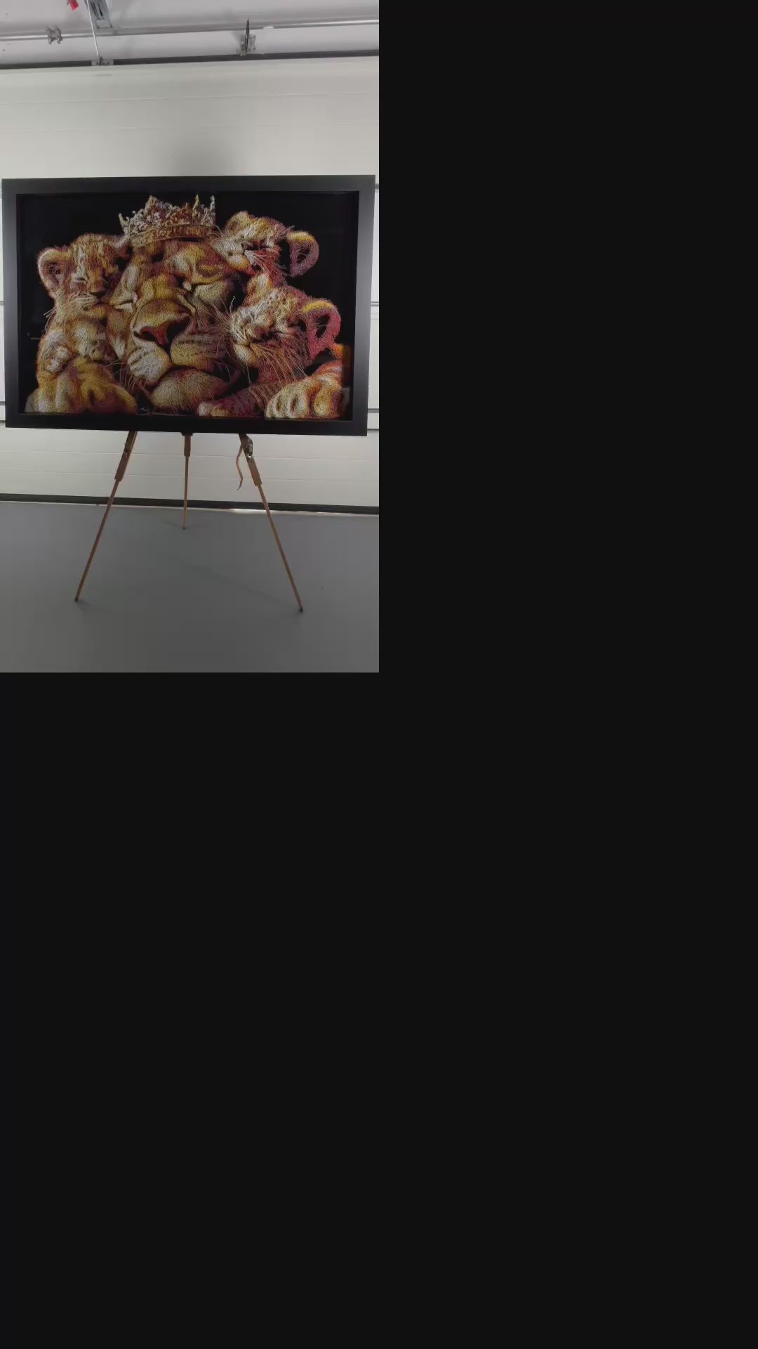 A richly textured injected-scribble artwork depicting a majestic lion wearing a crown, resting peacefully with three lion cubs nestled against him. The composition glows with warm tones of gold, amber, orange and cream, set against a deep black background that enhances the dimensional, thread-like detailing.