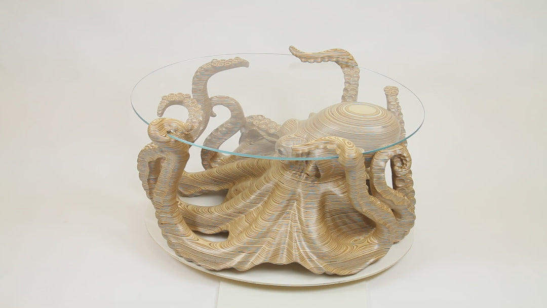 Hand-carved birch plywood octopus coffee table by Bill Prickett with sculptural tentacles supporting a low iron toughened glass top, combining functional furniture with detailed contemporary wood sculpture.