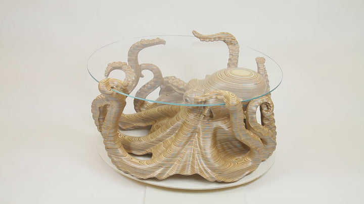 Hand-carved birch plywood octopus coffee table by Bill Prickett with sculptural tentacles supporting a low iron toughened glass top, combining functional furniture with detailed contemporary wood sculpture.