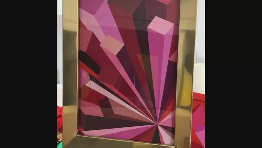 Rob Wyn Yates Metropolis – geometric abstract painting in vivid shades of pink, red, burgundy, and magenta, radiating from a central point with bold angular forms, set in a polished 1970s brass frame.