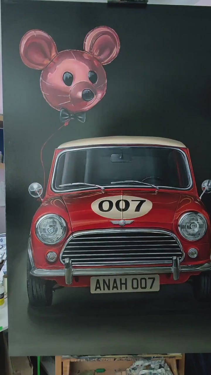 Video Hyperrealistic painting of a classic red Mini Cooper with cream roof viewed head-on, its grille and chrome bumpers gleaming against a deep black background. The bonnet bears a cream racing roundel with the number “007,” while above it floats a shiny pink mouse-shaped balloon with a black bow tie, tethered by a thin red string. Playful yet satirical, the scene humorously reimagines British motoring culture and spy glamour.