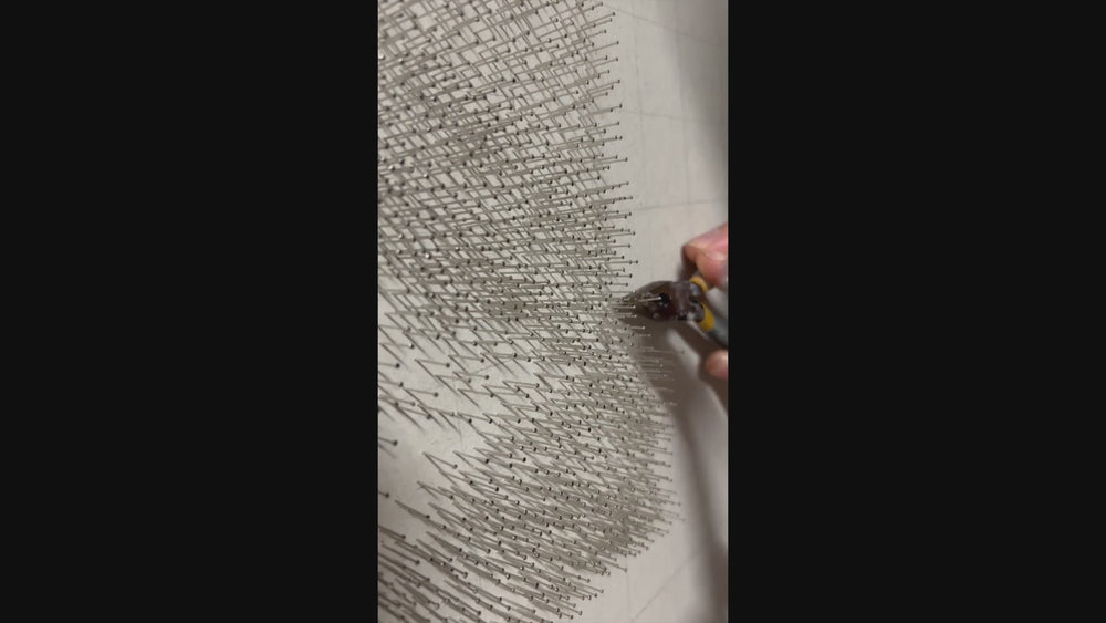 Hyperrealistic string art composition of a human eye, meticulously crafted with 9,200 pins and 200 metres of black string on a white fractured-edge acrylic panel, set against a glossy black background. The monochromatic detail highlights fine textures of lashes, iris, and skin.