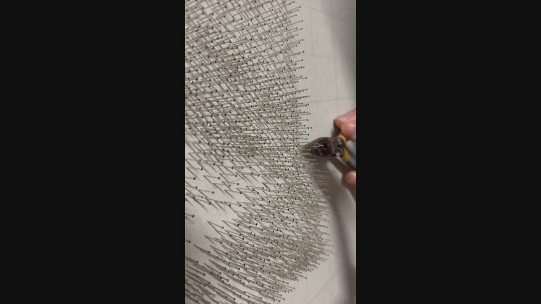 Hyperrealistic string art composition of a human eye, meticulously crafted with 9,200 pins and 200 metres of black string on a white fractured-edge acrylic panel, set against a glossy black background. The monochromatic detail highlights fine textures of lashes, iris, and skin.