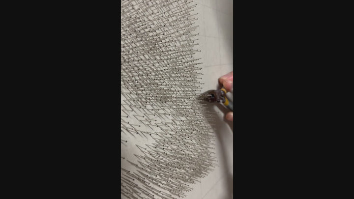 Hyperrealistic string art composition of a human eye, meticulously crafted with 9,200 pins and 200 metres of black string on a white fractured-edge acrylic panel, set against a glossy black background. The monochromatic detail highlights fine textures of lashes, iris, and skin.