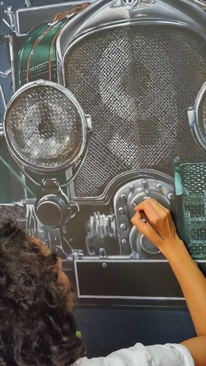 Video of Hyperrealistic frontal portrait of a 1929 Bentley Blower racing car painted with striking precision. The deep British racing green body, polished chrome grille, and massive headlights dominate the dark backdrop, creating a monumental, almost living presence. Rich mechanical textures and metallic reflections celebrate engineering heritage and pre-war endurance racing glory.