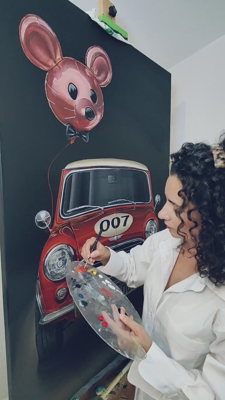 Video Hyperrealistic painting of a classic red Mini Cooper with cream roof viewed head-on, its grille and chrome bumpers gleaming against a deep black background. The bonnet bears a cream racing roundel with the number “007,” while above it floats a shiny pink mouse-shaped balloon with a black bow tie, tethered by a thin red string. Playful yet satirical, the scene humorously reimagines British motoring culture and spy glamour.