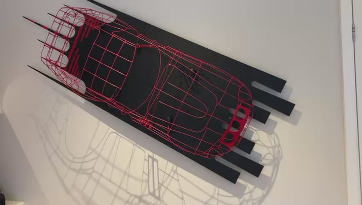 Handcrafted red wire sculpture of the Ferrari 250 GTO by Chris Twitchell, inspired by the original coachbuilder’s buck used to form the legendary 1962 Series 1 body. Finished in Rosso Chiaro red, this intricate wall-mounted artwork captures the elegance, form, and aerodynamics of Scaglietti’s design through sculptural craftsmanship and precision engineering.