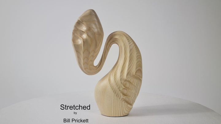 Hand-carved ash wood abstract sculpture with elongated, folded organic forms inspired by stretched sculpting wax and natural movement.