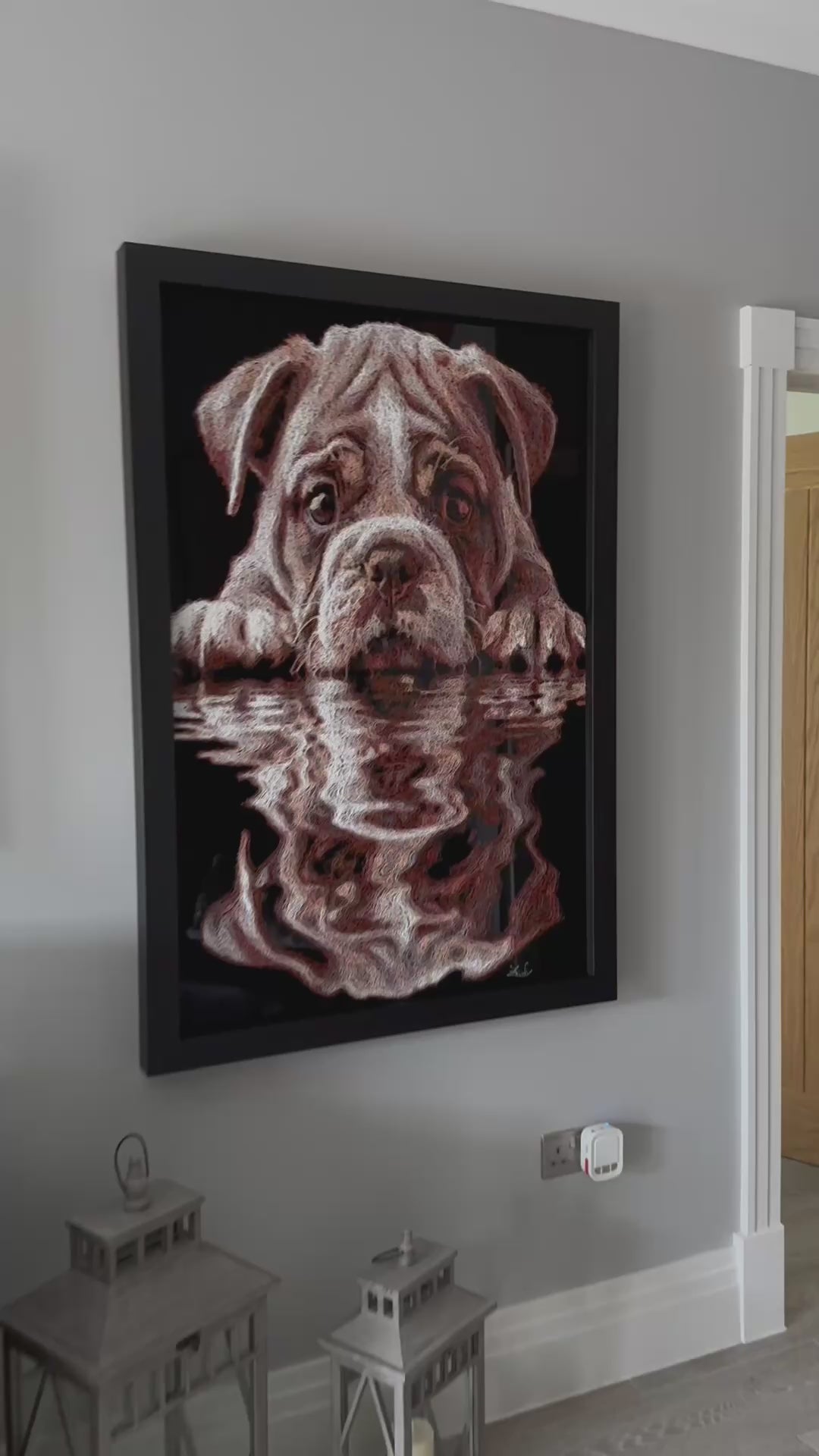 Vibrant injected-scribble artwork of a bulldog puppy resting at the edge of rippling water, its reflection distorted in swirling tones of white, tan, copper and brown, with dense textured linework creating a three-dimensional, energetic surface.
