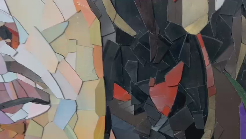 Video of Ed Chapman's Mosaic portrait of Bob Marley constructed from carefully cut fragments of reclaimed vinyl records, forming a highly detailed face with layered tonal variation and visible record grooves, set against a bold Rastafarian colour background that contrasts warm skin tones with strong graphic colour blocks and a textured, light-responsive surface.