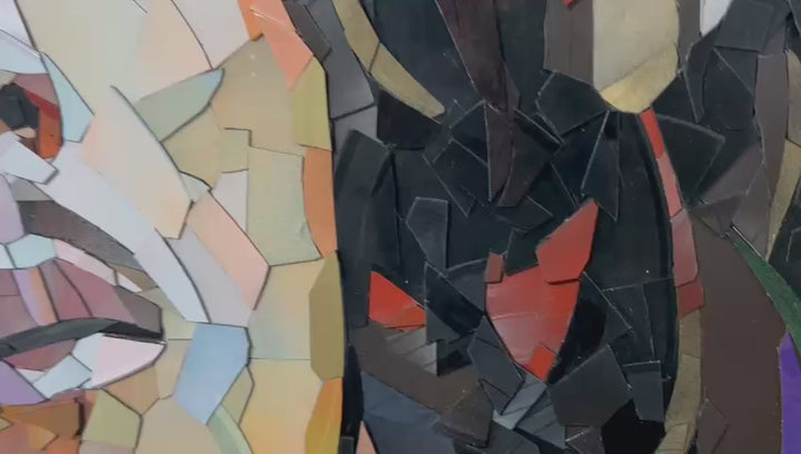 Video of Ed Chapman's Mosaic portrait of Bob Marley constructed from carefully cut fragments of reclaimed vinyl records, forming a highly detailed face with layered tonal variation and visible record grooves, set against a bold Rastafarian colour background that contrasts warm skin tones with strong graphic colour blocks and a textured, light-responsive surface.