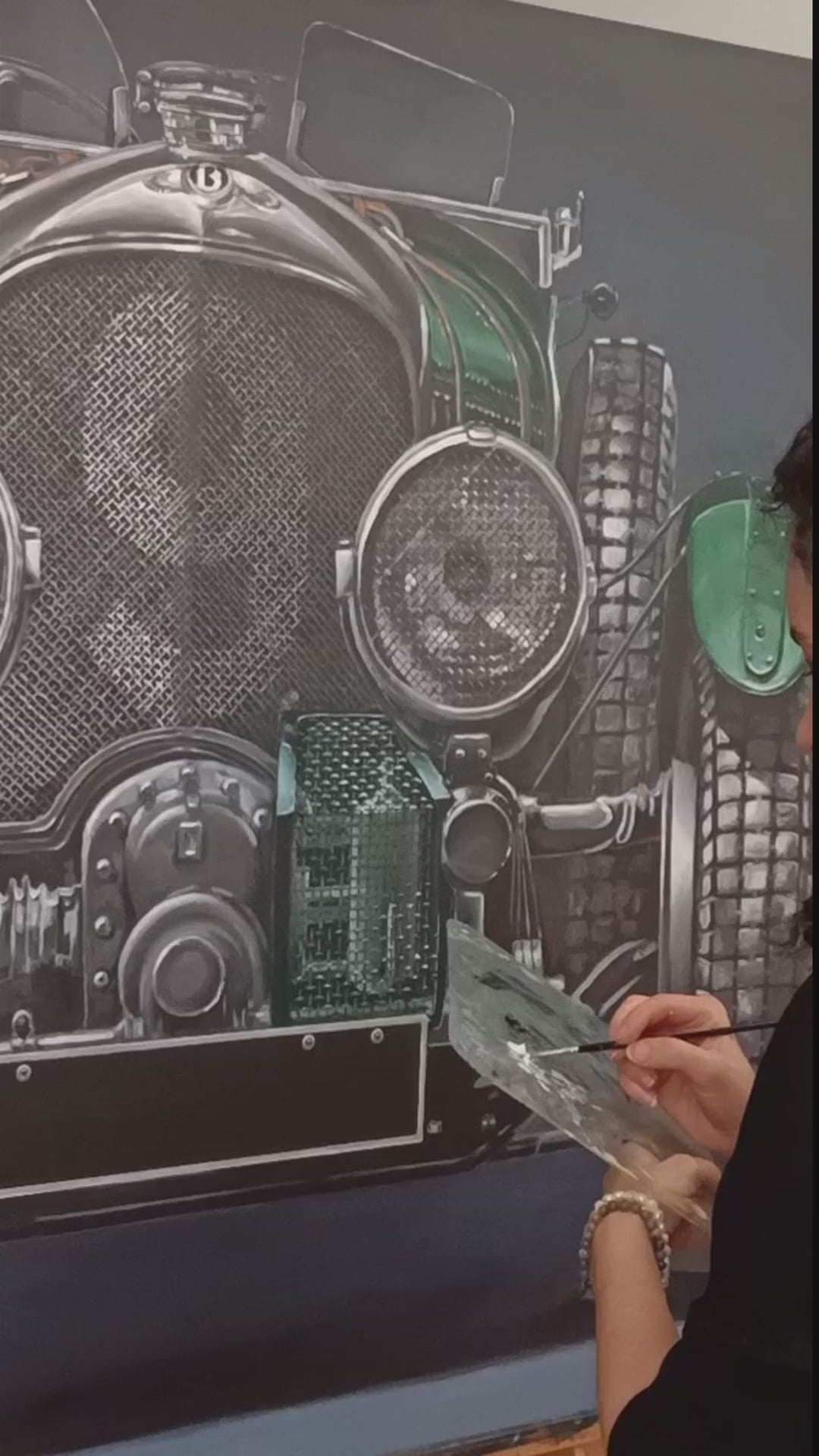 Video of Hyperrealistic frontal portrait of a 1929 Bentley Blower racing car painted with striking precision. The deep British racing green body, polished chrome grille, and massive headlights dominate the dark backdrop, creating a monumental, almost living presence. Rich mechanical textures and metallic reflections celebrate engineering heritage and pre-war endurance racing glory.
