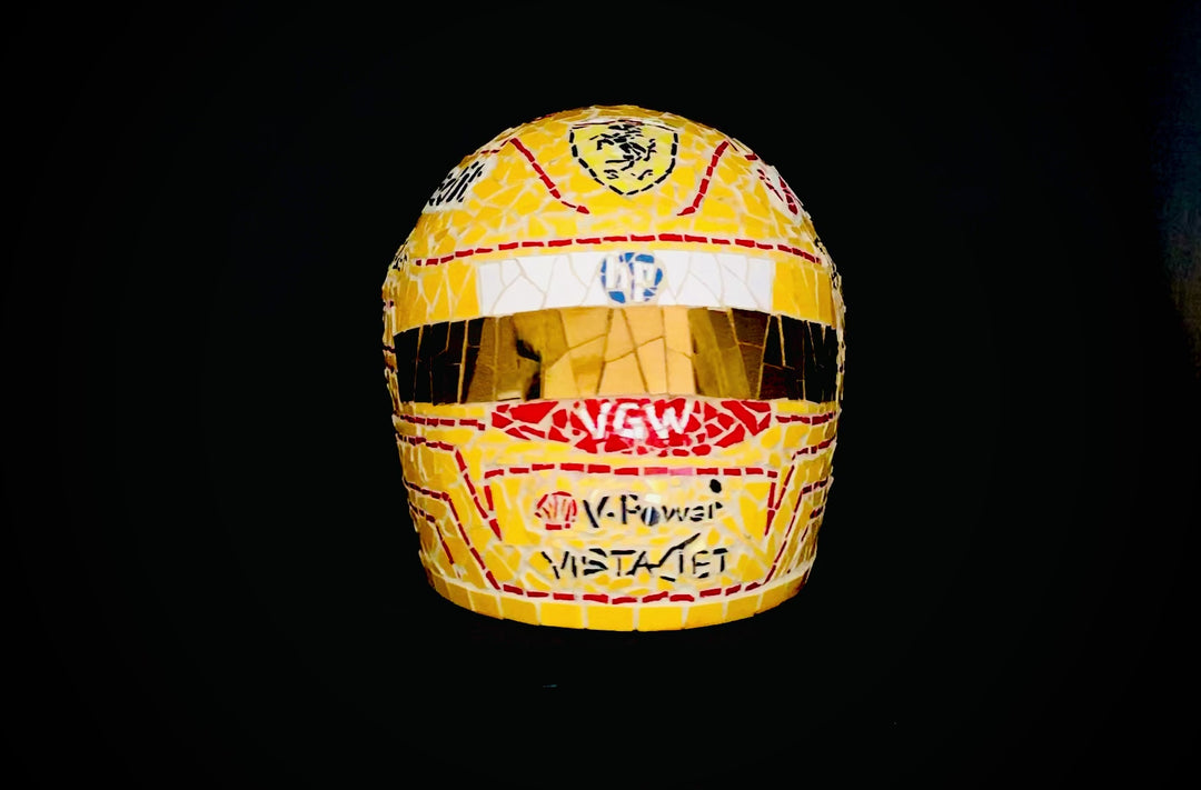 Full-size Ferrari-inspired Formula 1 helmet mosaic sculpture, handcrafted from individually cut ceramic tiles in red, yellow, white, black, and metallic gold. This bespoke artwork captures the energy and precision of motorsport design, created as an example of a custom commission.