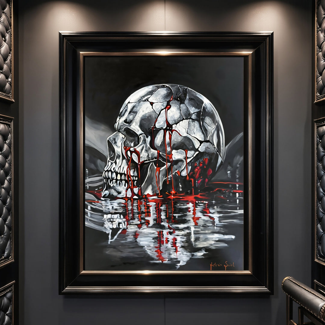 Victoria Saint Stillwater print of a fractured silver skull resting above dark reflective water, with soft red tones flowing into the surface, exploring themes of endurance, release and quiet reflection.