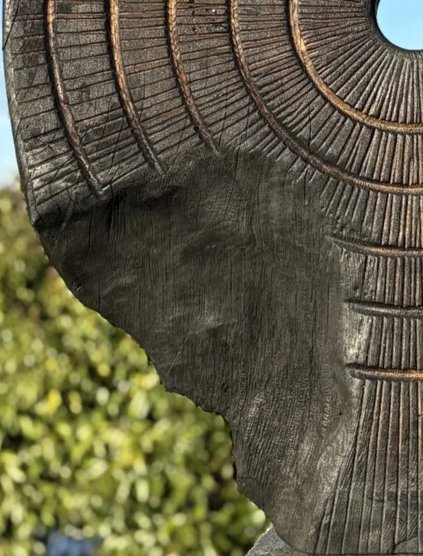 Charred oak sculpture by Glen Farrelly titled Ritual, carved with concentric cup and ring markings around a central void. Blackened Yakisugi surface contrasts with golden highlights, evoking ancient standing stones and ritual energy.