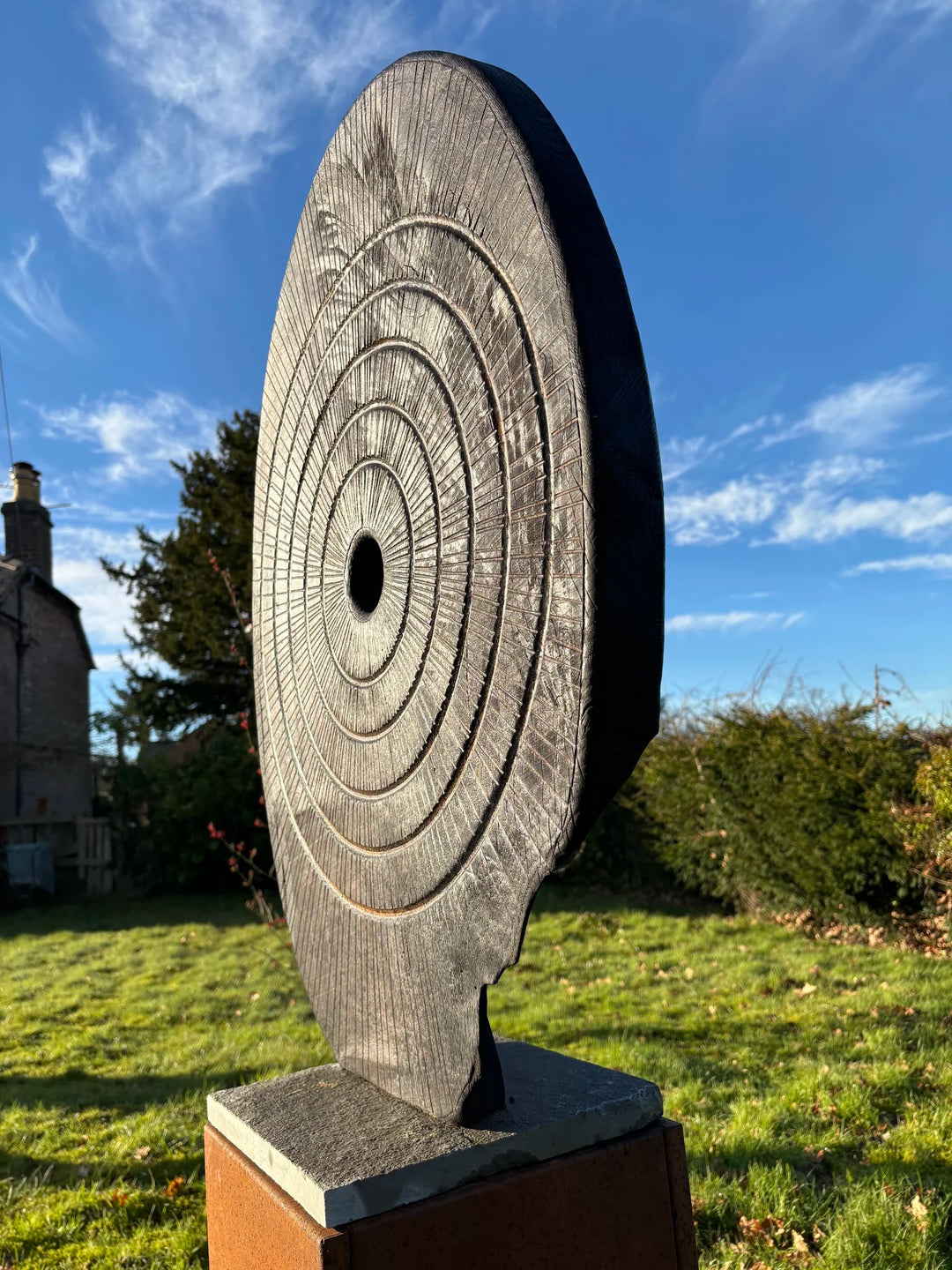 Charred oak sculpture by Glen Farrelly titled Ritual, carved with concentric cup and ring markings around a central void. Blackened Yakisugi surface contrasts with golden highlights, evoking ancient standing stones and ritual energy.