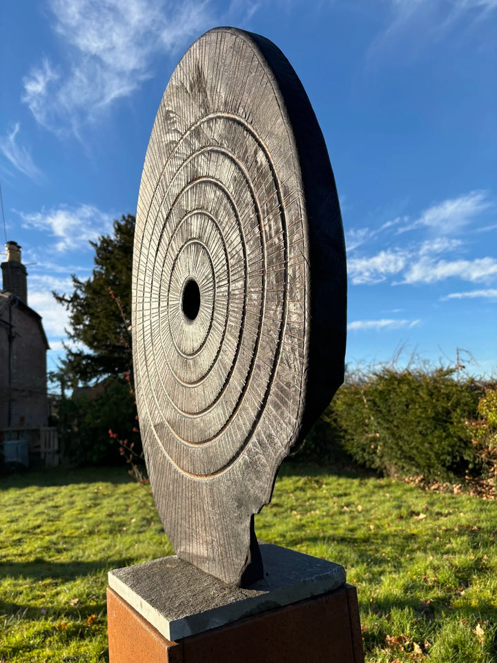 Charred oak sculpture by Glen Farrelly titled Ritual, carved with concentric cup and ring markings around a central void. Blackened Yakisugi surface contrasts with golden highlights, evoking ancient standing stones and ritual energy.