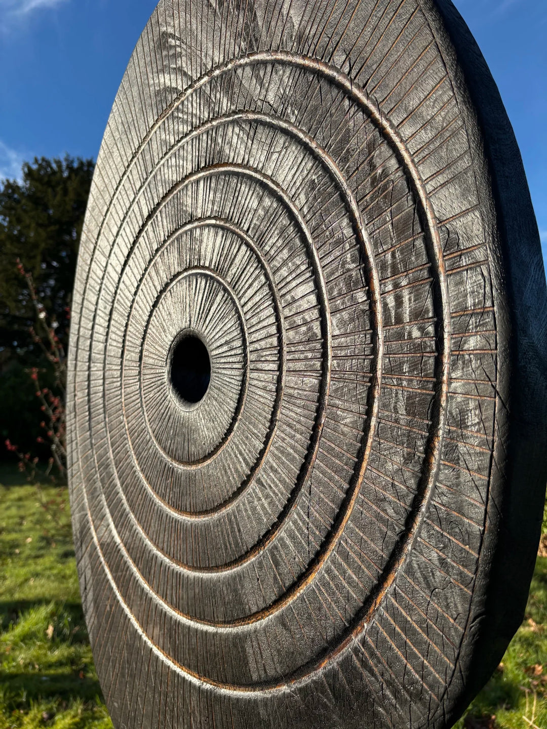 Charred oak sculpture by Glen Farrelly titled Ritual, carved with concentric cup and ring markings around a central void. Blackened Yakisugi surface contrasts with golden highlights, evoking ancient standing stones and ritual energy.