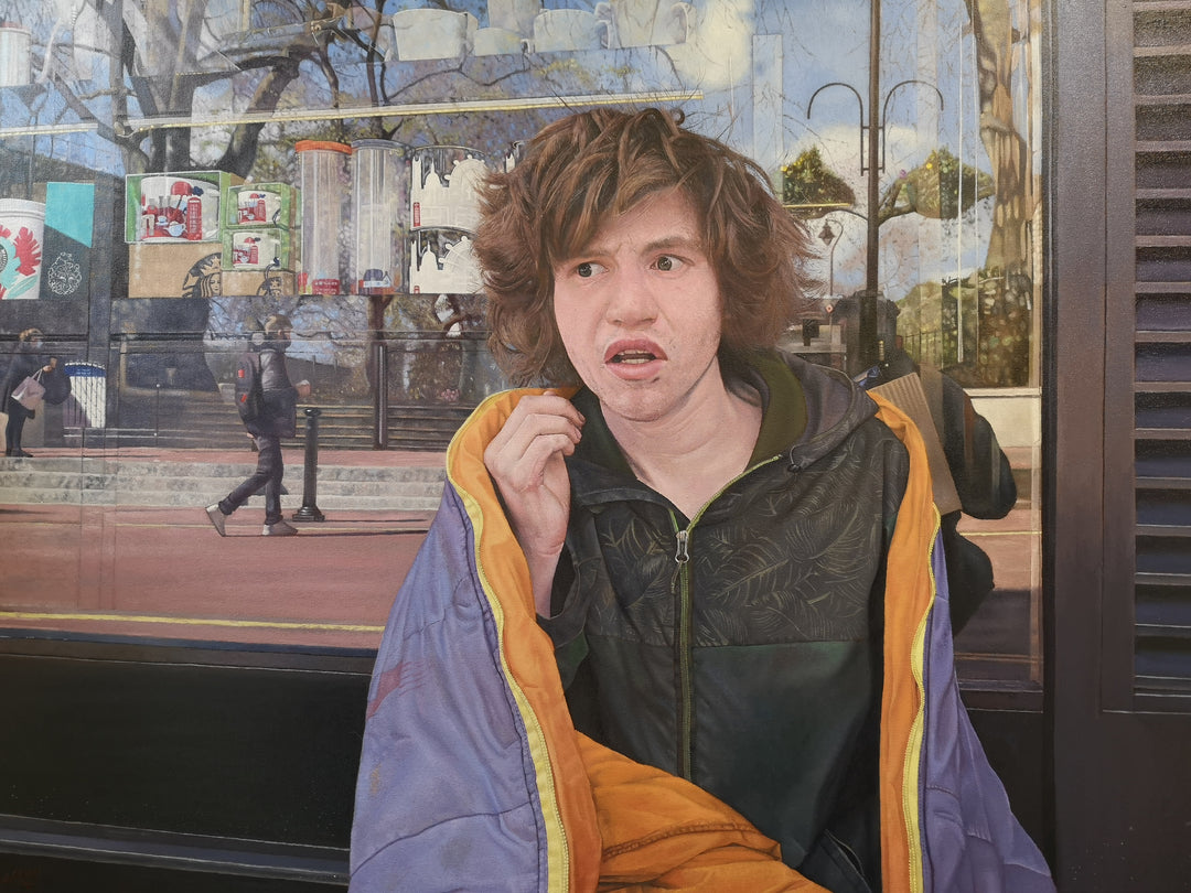 Rory by James Earley — a hyperrealist oil painting portraying a homeless teenage boy seated outside a London storefront, wrapped in a weathered coat with expressive eyes and an uncertain expression, while the window behind him reflects passing pedestrians and commercial branding, symbolising a world moving on without him.