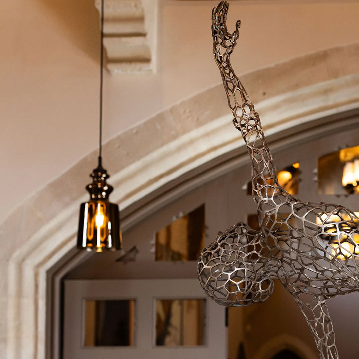 ‘Parallel Passé’ by Simon Gudgeon, a limited-edition figurative bronze sculpture inspired by Prima Ballerina Ksenia Ovsyanick. The life-size female dancer is captured en pointe in an elegant, dynamic ballet pose, formed through an intricate open Voronoi lattice that allows light and the surrounding environment to pass through and transform the sculpture.
