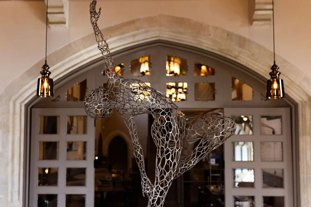‘Parallel Passé’ by Simon Gudgeon, a limited-edition figurative bronze sculpture inspired by Prima Ballerina Ksenia Ovsyanick. The life-size female dancer is captured en pointe in an elegant, dynamic ballet pose, formed through an intricate open Voronoi lattice that allows light and the surrounding environment to pass through and transform the sculpture.